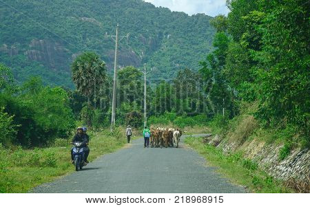 Long Xuyen Vietnam - Sep 1 2017. People and vehicles on rural road in Long Xuyen Vietnam. Long Xuyen is the provincial city and capital city of An Giang Province.