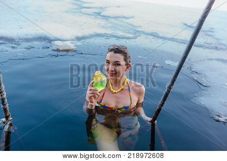 Novokuznetsk, Kemerovo region, Russia - 23 Feb, 2017 : White beaches of Siberia is an enterteiment activity where people playing beach games dressed in bikini in winter. Woman in an ice hole