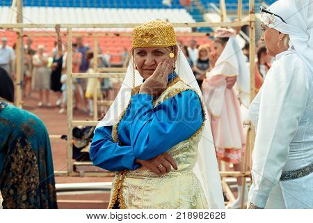 Yoshkar-Ola, Russia - Jule 23, 2016 An adult woman in a Tatar national costume at the DRUZHBA stadium during the Tatar national festival