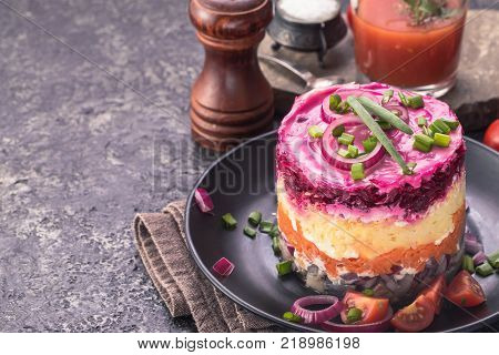 Herring under a fur coat and tomato juice with copy space. Russian national cuisine