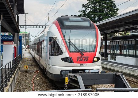 Locarno Switzerland - May 28 2016: A passenger train of the TILO (Regional Train Ticino Lombardia) at a platform of the Locarno railway station.