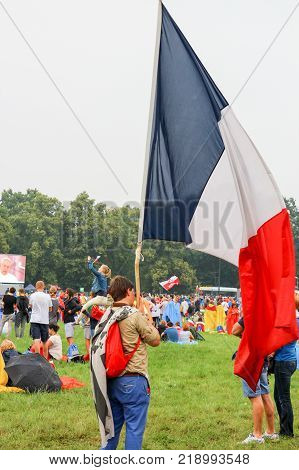 KRAKOW POLAND - 2016- Krakow Blonia World Youth Day 2016 a young guy holding a big flag of France