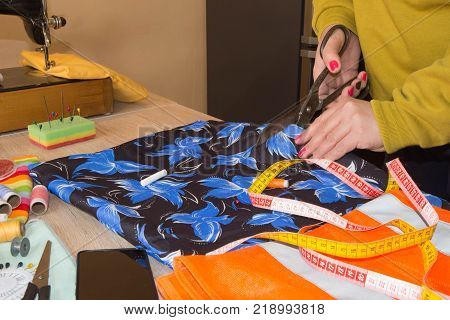 Close-up of woman's hand stitching quilting. Tailor Woman working in his tailor shop Tailoring. Garment industry tailoring concept