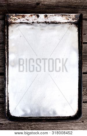 Old Vintage Baking Pan And Tins On Wooden Background. Selective Focus.