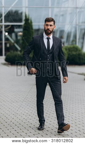 Confident Businessman. Confident Young Man In Full Suit Adjusting His Sleeve And Looking Away While 