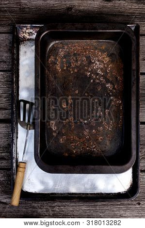 Old Vintage Baking Pan And Tins On Wooden Background. Selective Focus.