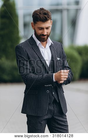 Confident Businessman. Confident Young Man In Full Suit Adjusting His Sleeve And Looking Away While 