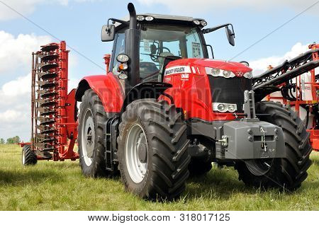 Cherkasy, Ukraine - May 18, 2018: Modern Massey Ferguson Tractor Model 7724 With Modern Plough  Exhi