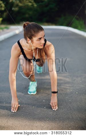 Vertical Shot Athletic Sporty Woman Standing Low Start On Concrete Road In Empty Park, Look Aside, L