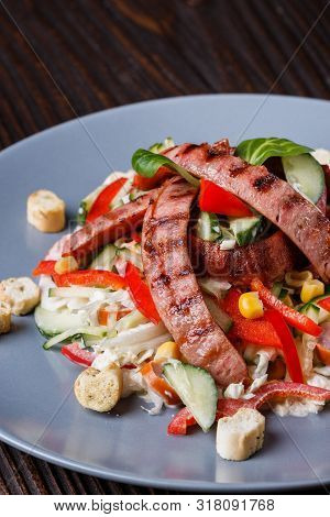 Salad With Grilled Sausage Paprica Cucumber And Croutons
