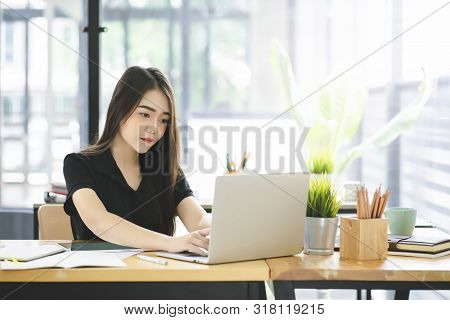 Young Asian Graphic Designer Working On Computor And Graphics Tablet In Her Working Space
