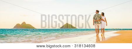 Couple walking on beach sunset vacation panoramic hawaii travel. Woman and man relaxing on tourist holiday in Lanikai, Oahu, Hawaii banner.