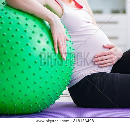 Pregnant woman exercising in anticipation of child birth
