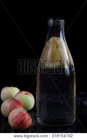 Apple Kompot In Glass Bottle On Black The Background