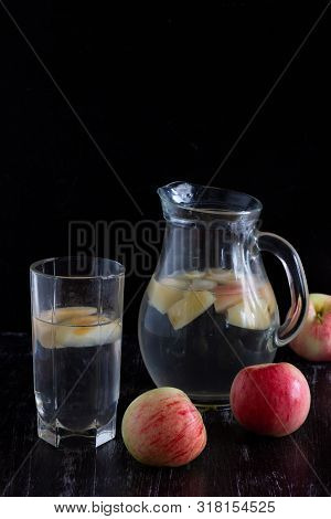 Apple Kompot In Glass Bottle On The Black Background