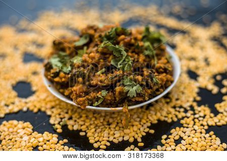 Famous Indian Punjabi Dish I.e. Roasted Dal With Spinach In A Glass Plate On The Wooden Surface Alon