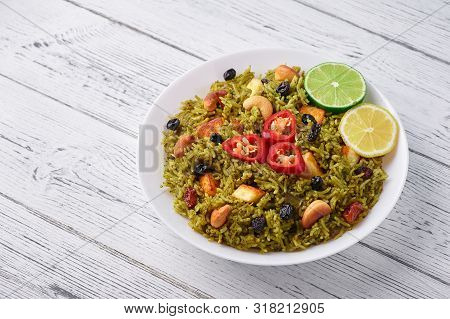 Palak Paneer Biryani At White Wooden Background. Palak Paneer Biryani Is Vegetarian Indian Cuisine D