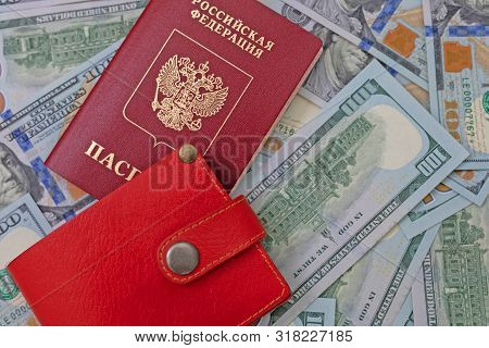 Russian International Passport On A Background Of Dollars. A Russian Citizen Is Going Abroad, Exchan