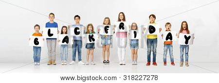 Black Friday, Sales Concept. Group Of Childrens, Kids And Teens In Bright Clothing With Emotions Of 