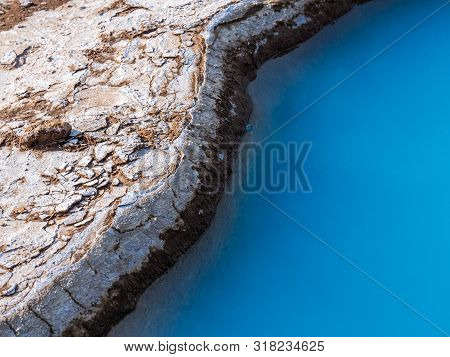 Blue Geothermal Pond At The Great Geysir, An Active Volcanic Geyser In Southwestern Iceland