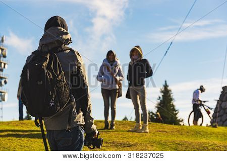 Schockl Mountain, Graz, Austria - 23.10.2016: Three Young Persons At The Peak Of The Mountain Making