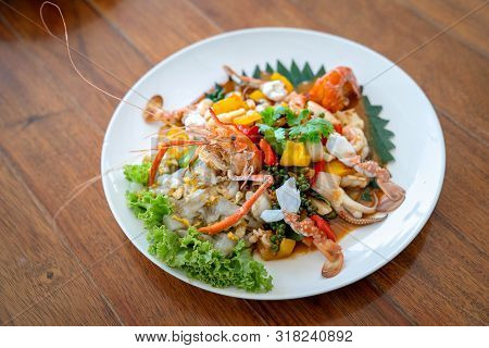 Seafood Thai Mixxed Together Between Boiled Shrimp, Crab, Squid And Colourful Vegetable In Dish On W