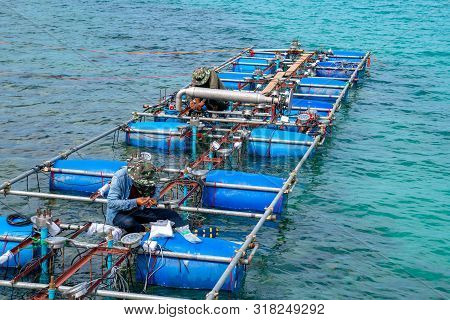 Workers Settle And Setup The Waterworks Fountain Machine On The Surface Of The Sea.