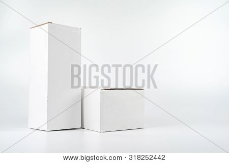 White Two Paper Boxes - Tall And Fat Lay On The White Background In Studio Shot With Clipping Paht.