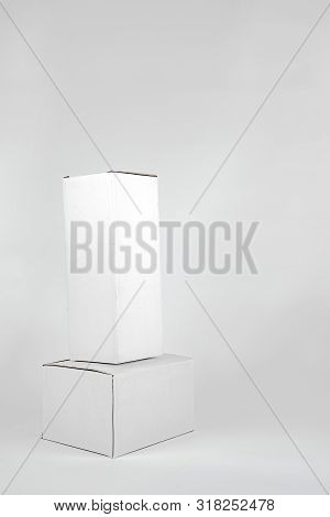 White Two Paper Boxes - Tall And Fat Lay On The White Background In Studio Shot With Clipping Paht.