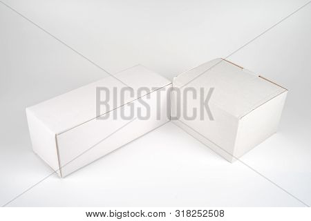White Two Paper Boxes - Tall And Fat Lay On The White Background In Studio Shot With Clipping Paht.