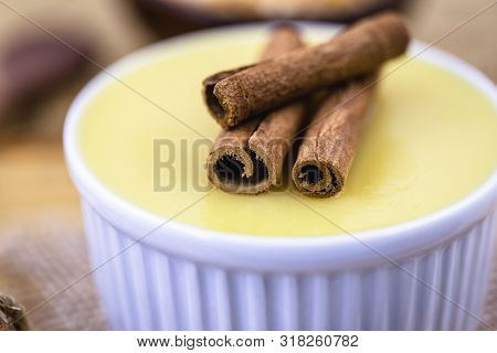 Dessert Of Curau. Brazilian Sweet Corn, Corn Mousse With Cinnamon On A Wooden Background. Typical Br