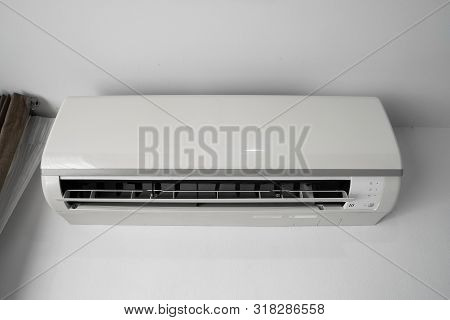 Air Conditioner Mounted On A White Wall In The Living Room Or Bedroom. Indooor Comfort Temperature. 
