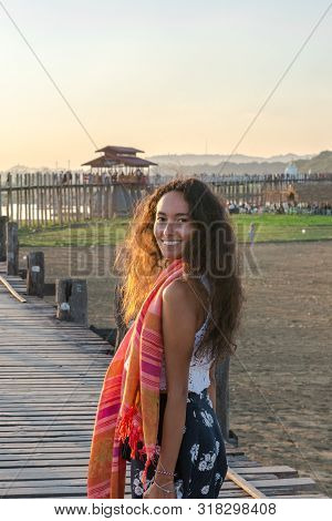 Vertical Picture Of Foreigner Tourist Model Showing Hapiness At U Bein Bridge, A Landmark Of Mandala