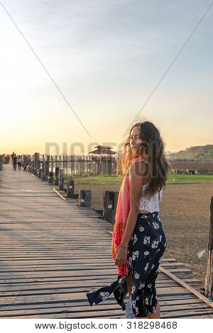 Vertical Picture Of Beautiful Model Posing At U Bein Bridge During Sunset Time In Mandalay, Myanmar
