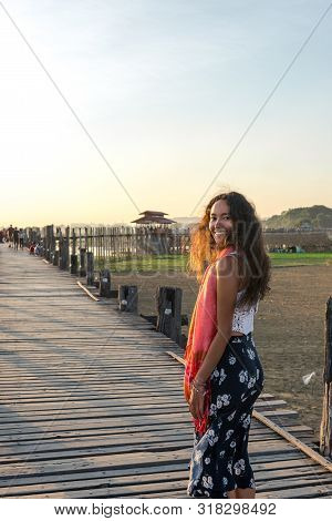 Vertical Picture Of Beautiful Model Smiling At U Bein Bridge During Sunset Time In Mandalay, Myanmar