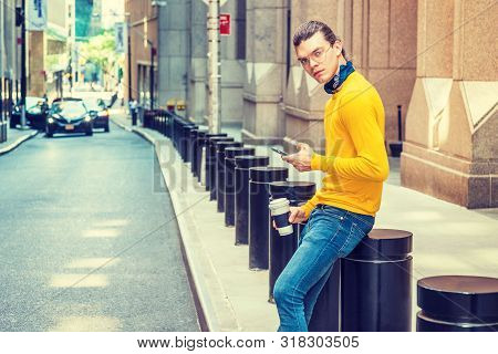 Working Break. Young Hispanic American With Hair Bun, Wearing Glasses, Yellow Long Sleeve T Shirt, B