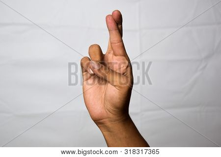 Close Up Asian Man Shows Hand Gestures It Means Fingers Crossed Isolated On White Background