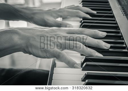 Hand Of Piano Player On White Keys And Black Keys Of Electric Piano In Zoom View