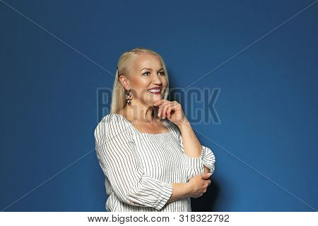Portrait Of Beautiful Mature Woman On Blue Background