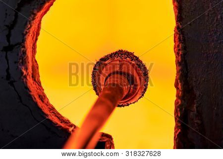 Glass Blower Manufacturing Process, Working On A Bubble Of Melted Glass On A Rod By Heating It Up By