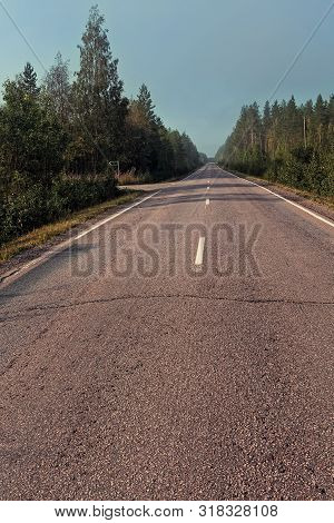 The Mist Covers The Empty Road On A Late Summer Morning At The Rural Finland. There Are Nobory Drivi