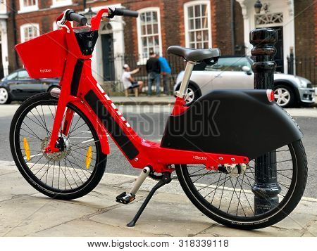 LONDON, UK - AUGUST 21, 2019: A Jump dockless electric bicycle parked on the pavement in a street in North London, UK.