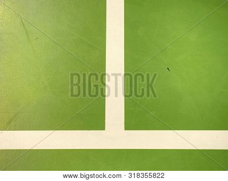 White Lines Painted On Green Inside Florr. Sporty School Hall. Players Out Of Focus.