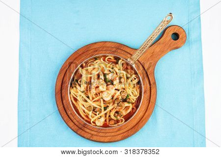 Mediterranean pasta with shrimps, onions, cucumbers and hot peppers