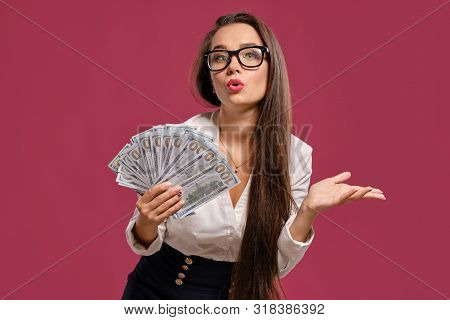Brunette Girl In Glasses, Wearing In A Black Short Skirt And White Blouse Is Posing Holding A Fan Of