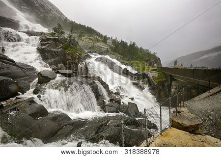 Waterfall Langfoss Located On The Lake Stordalsvatnet, Norway