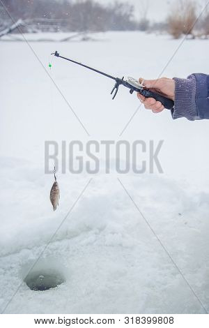 Close Up Of A Ricky Fisherman With A Fishing Rod. Ice And Fishing Rod For Winter Fishing. Winter Fis