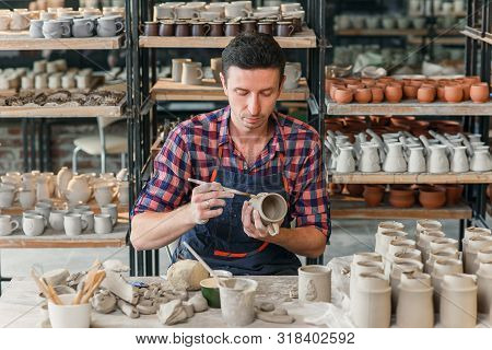 Talanted Caucasian Man Making Decoration For Cup.
