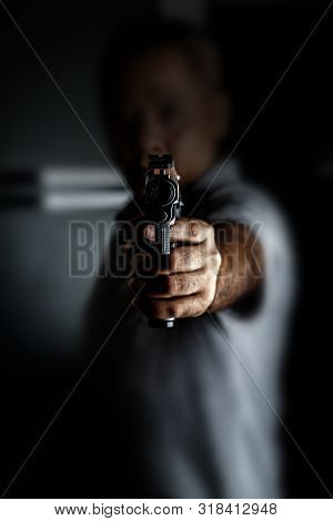 Man Carrying A Toy Gun To Rob The Money. Robber In The Shadow With Toy Gun Rob Money. Concept Pictur