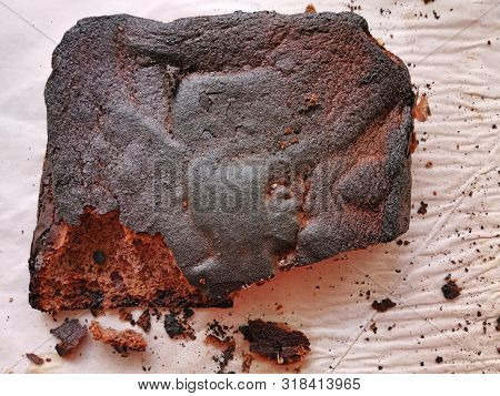 Close Image Of Over Burned Pie On Baking Paper, Cooking Error Cake